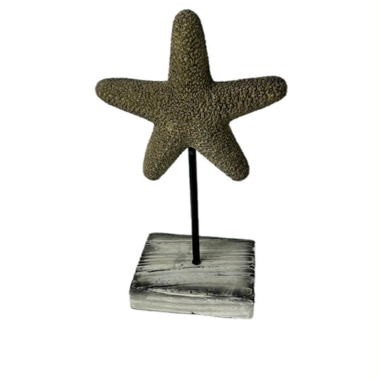 Decorative starfish on a wooden stand against a white background